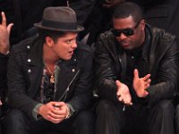 Bruno Mars  Courtside wearing green chucks with black shoelaces.